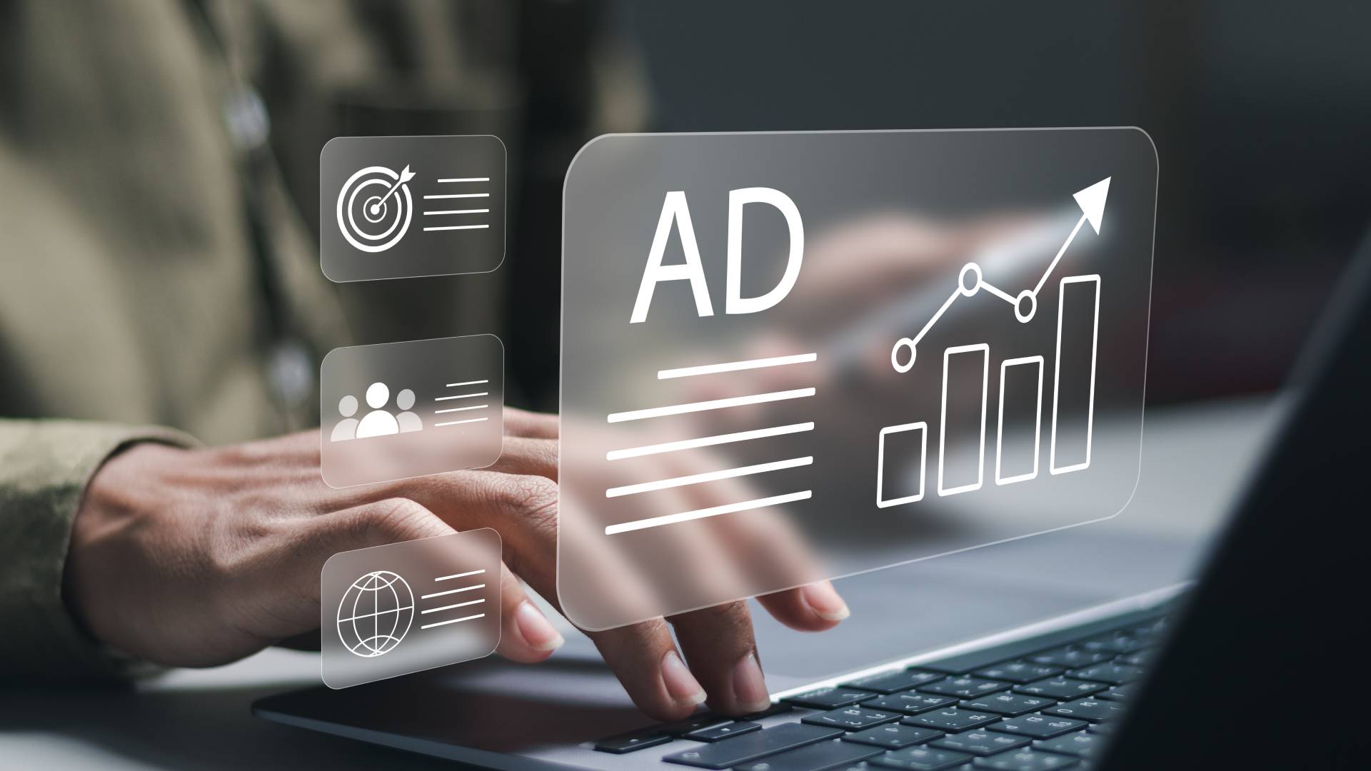 A graphic box featuring the word "AD" next to an ascending bar chart hovers above a laptop in front of a blurred man.