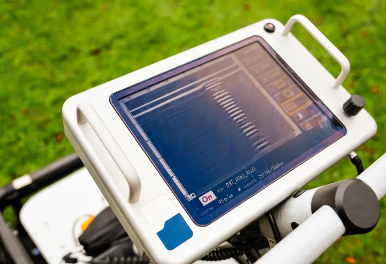 A close-up of the touchscreen of a ground-penetrating radar screen mounted to the top of the radar detector.
