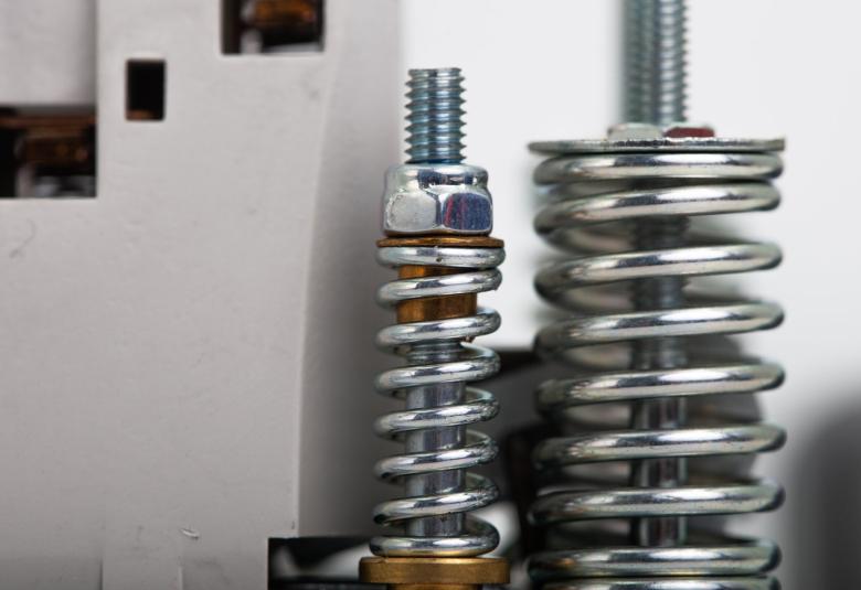 A close-up view shows a disassembled solenoid valve with a metal coil and a copper piece in the middle.